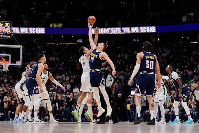 Denver Nuggets center Nikola Jokic (15) and Milwaukee Bucks center Brook Lopez (11) tipoff